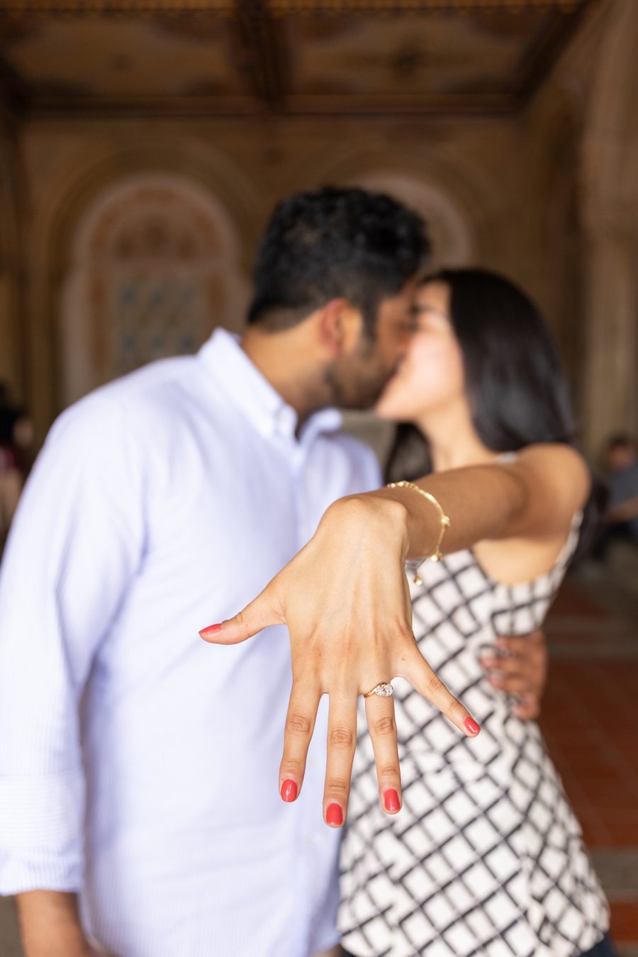 Daniela showing her engagement ring while they kiss